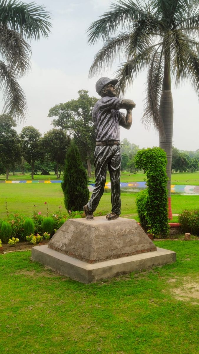Soldier statue on a pedestal in a landscaped lawn