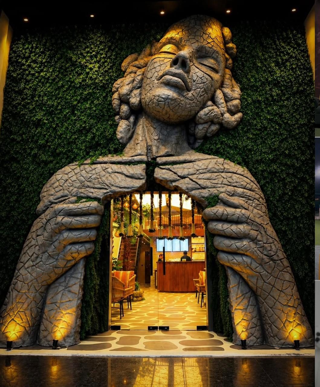 Giant FRP sculpture of a face and hands framing the entrance of Xebhium Café, Mohali