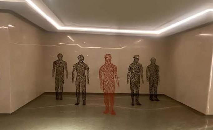 Life-size human figures made of MS rods in a building lobby