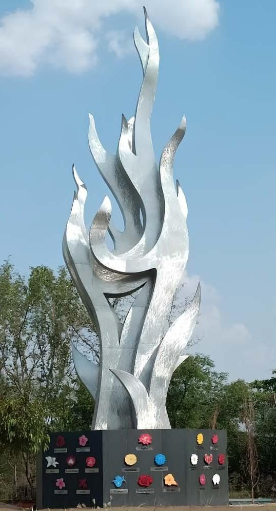 Tall stainless steel flame-form landmark sculpture